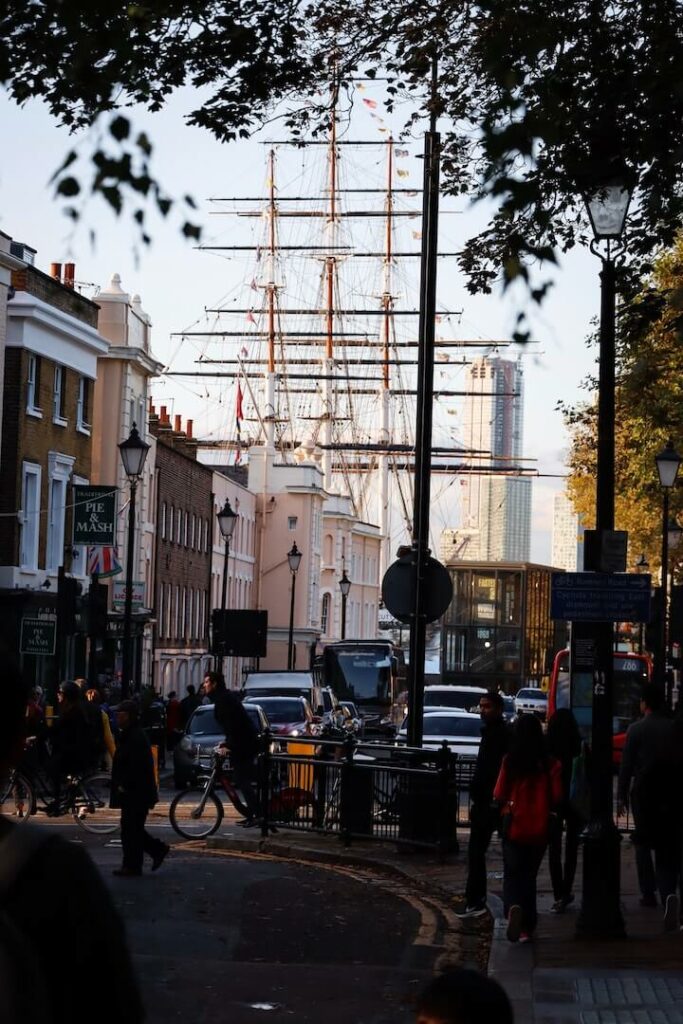 Busy Greenwich street, London with Cutty Sark in the background
